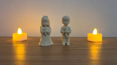 Niñitos sujetando una vela de frente